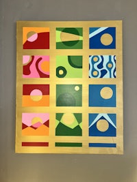 a painting with colorful squares hanging on a wall