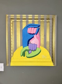 a painting on a wall with a hand in it