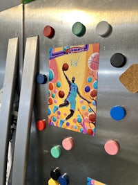 a magnet with a picture of a basketball player on it