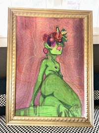 a painting of a woman in a gold frame